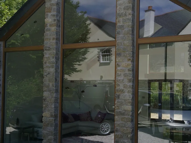 Hardwood (Sepele) fixed screens. Double Glazed. Light Oak stain finish. Location Altarnun.